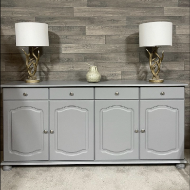 sustainable refurbished furniture example of a side board repainted in grey with two lamps placed upon it